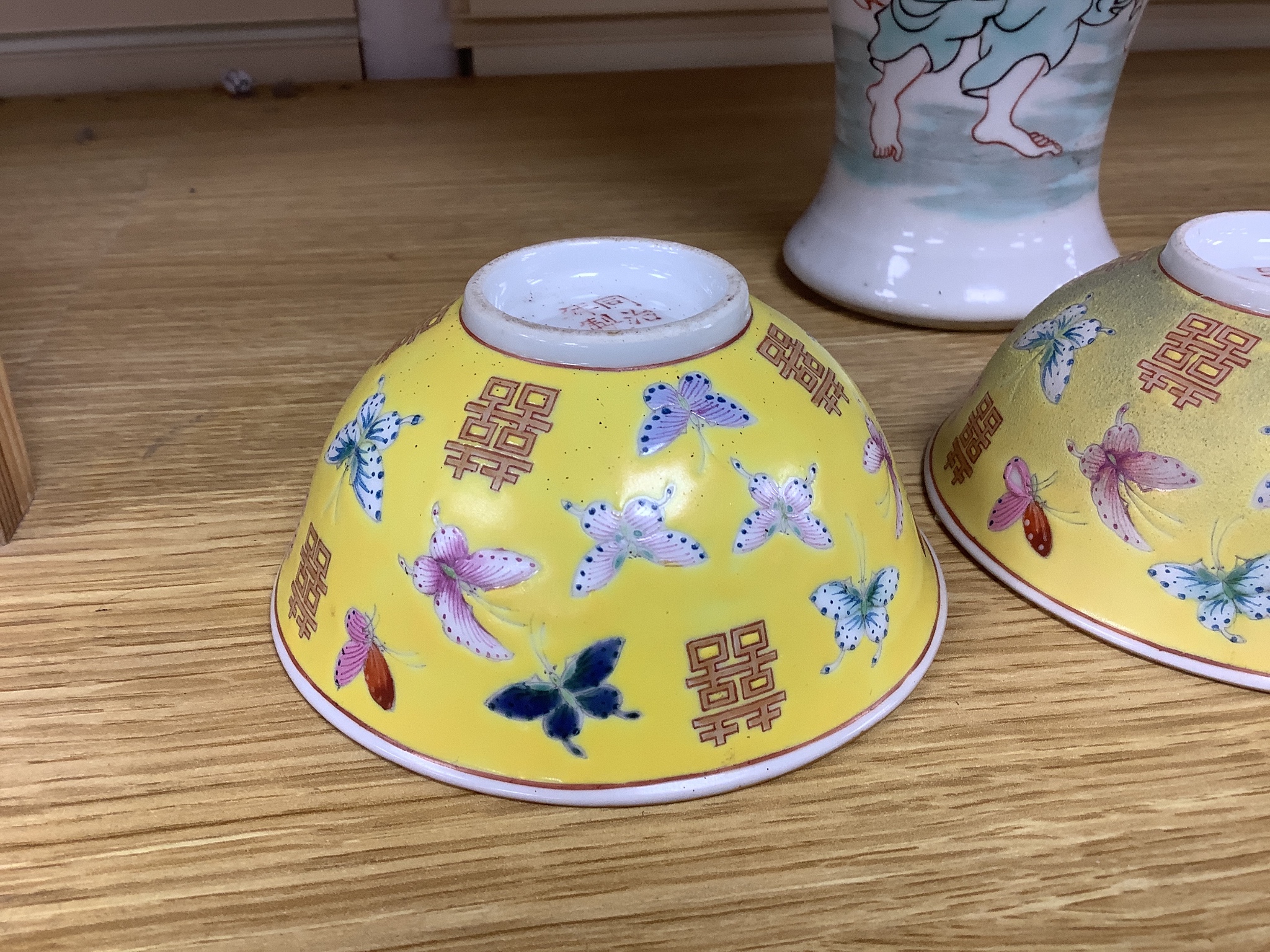 A pair of Chinese yellow ground porcelain small bowls, enamelled with butterflies, diameter 11cm